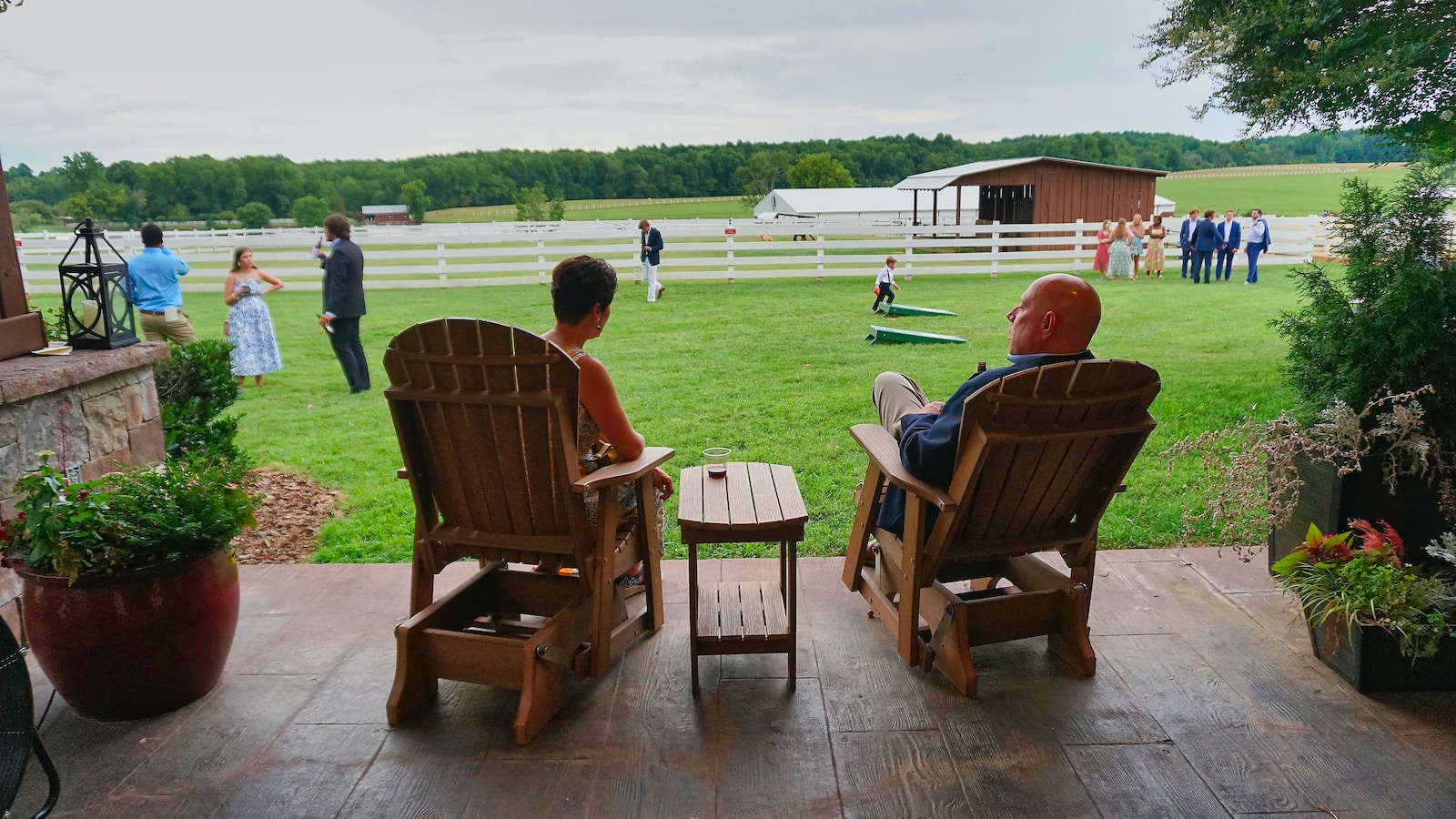 two people sitting in chairs on a deck